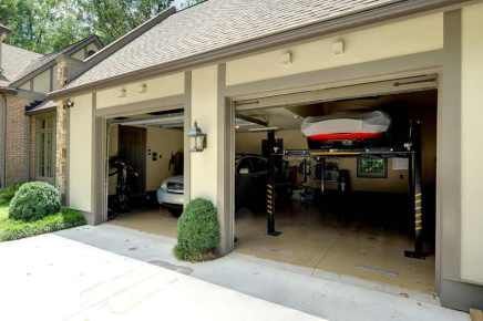 There is a boat in the garage of a house.