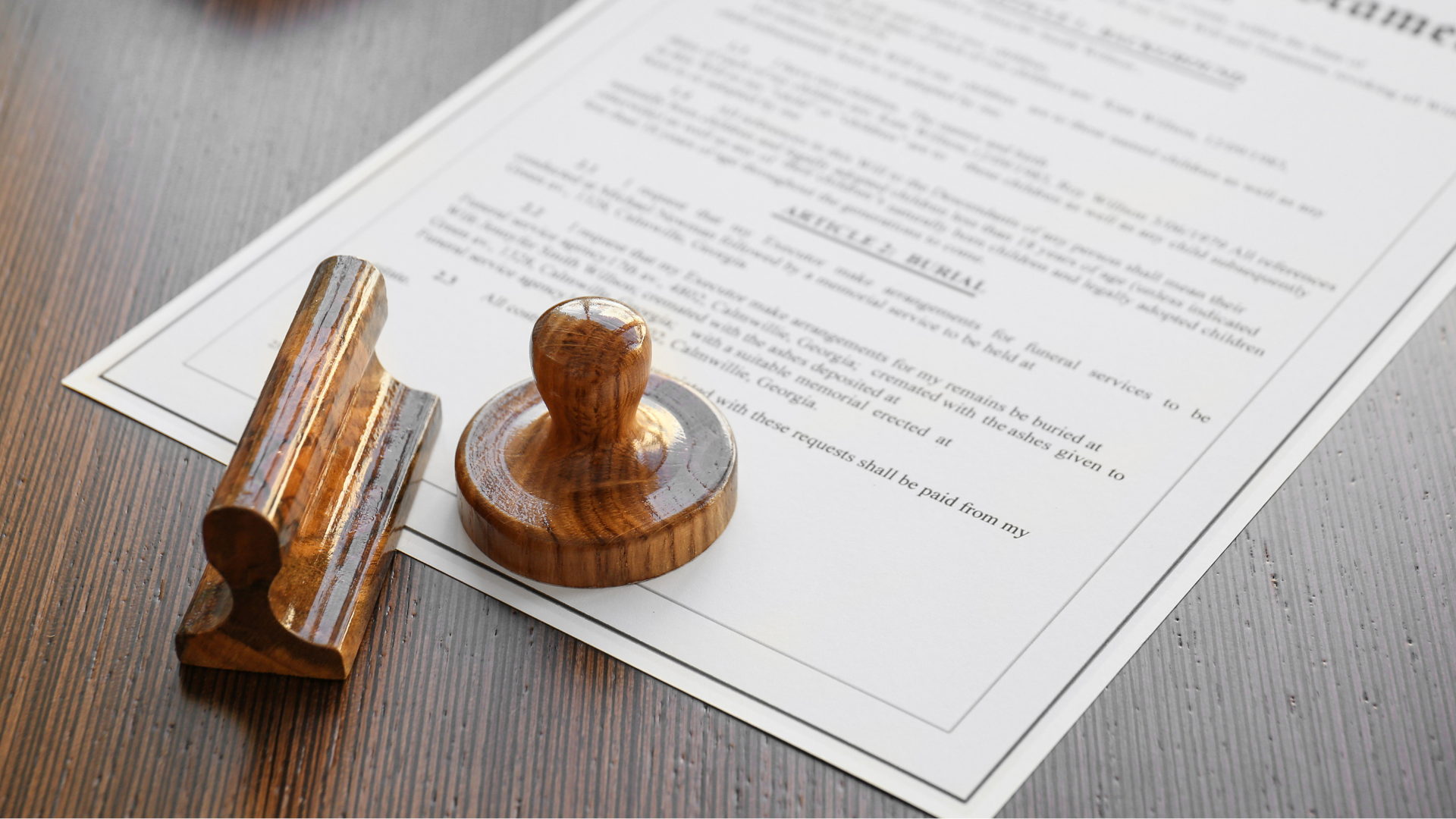 Wooden stamp on a document with text, on a wooden table.