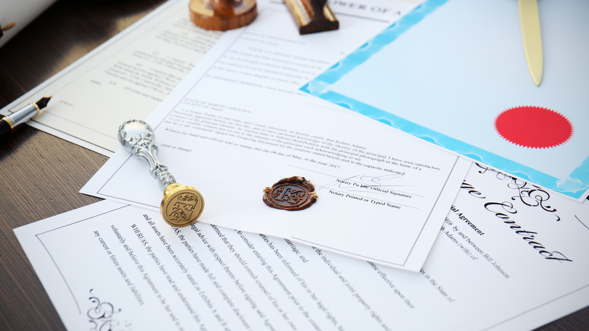 Documents with wax seals and stamps on a wooden surface.