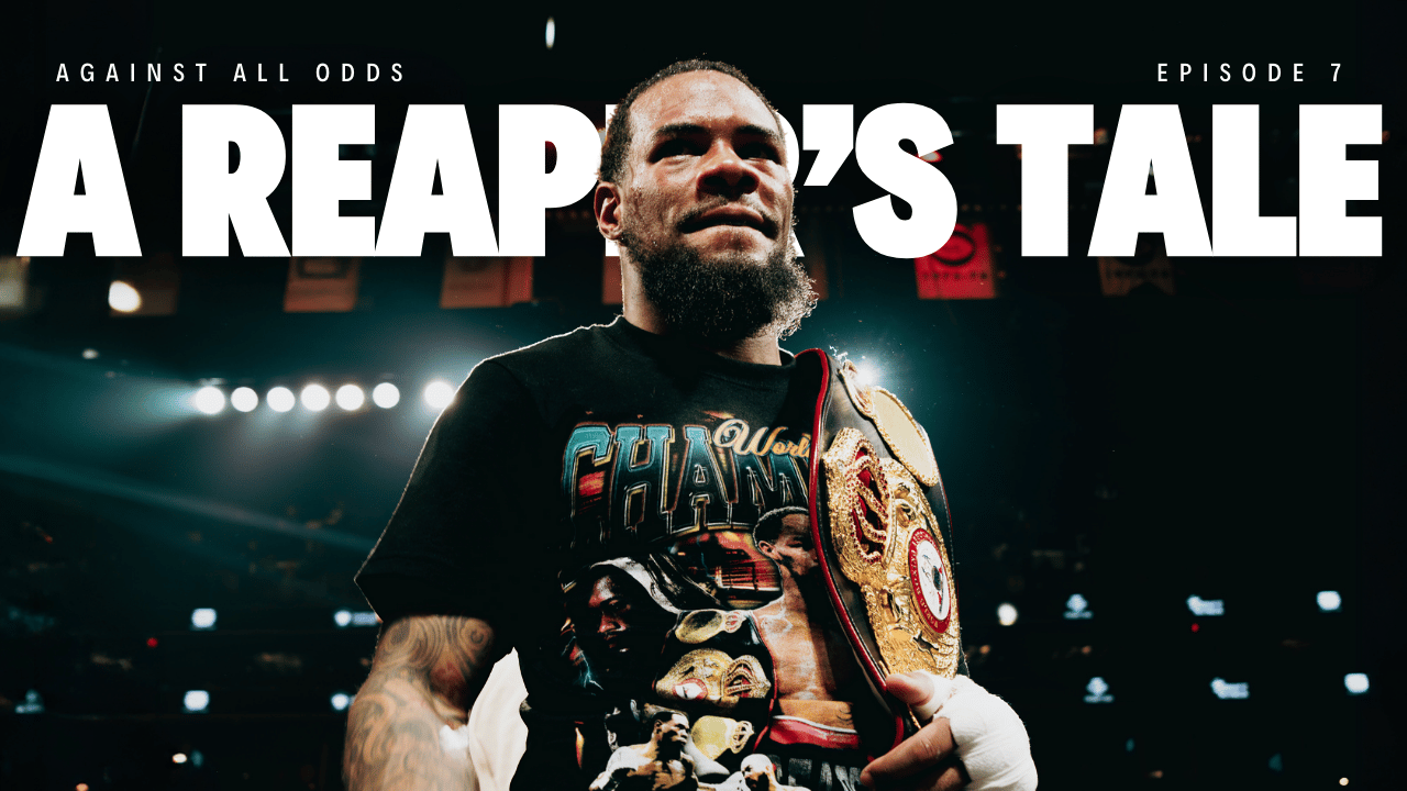 Boxer with championship belt in a ring, wearing 