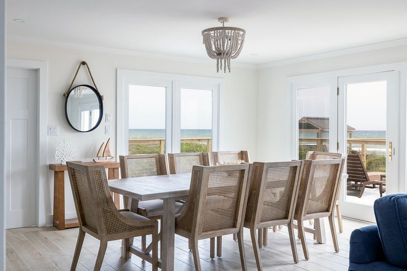 A dining room with a table and chairs and a blue couch.