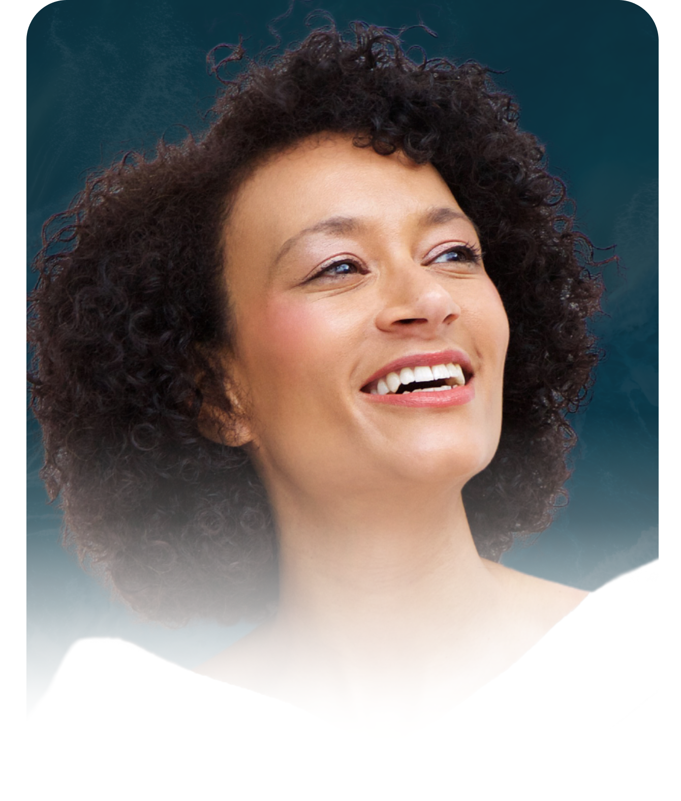 A woman with curly hair is smiling and looking up