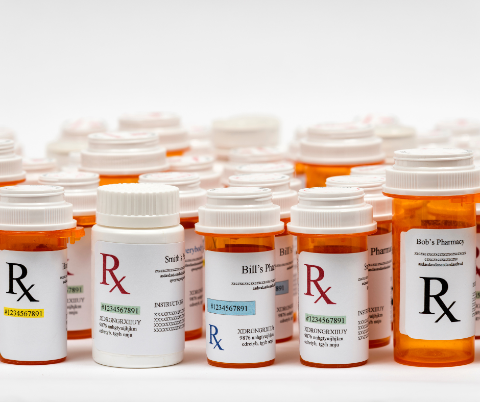 Multiple orange prescription medication bottles with white caps arranged in rows, showing various Rx