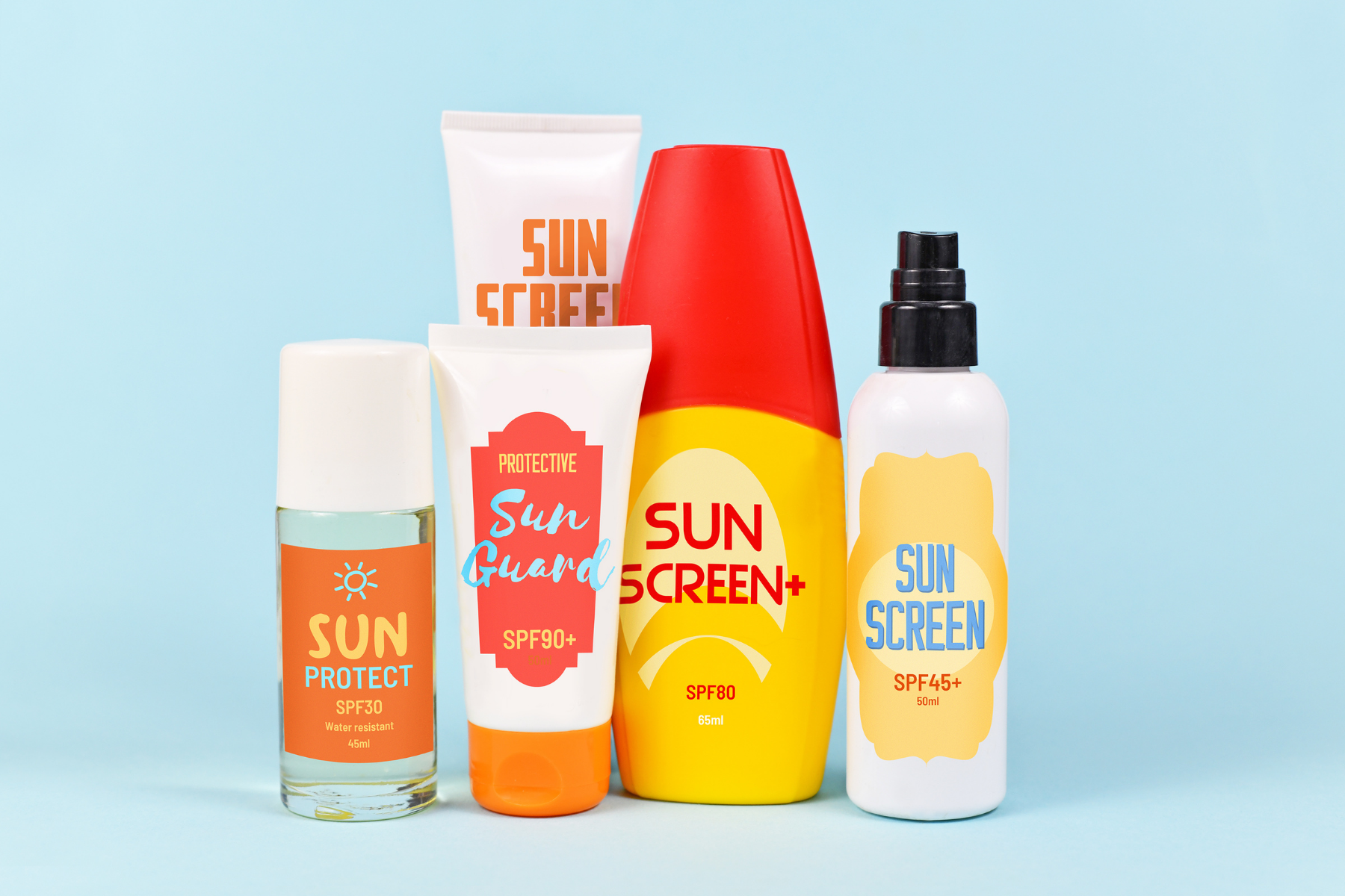 Various sunscreen products arranged against blue background demonstrating protection needed for lupus and sunlight sensitivity