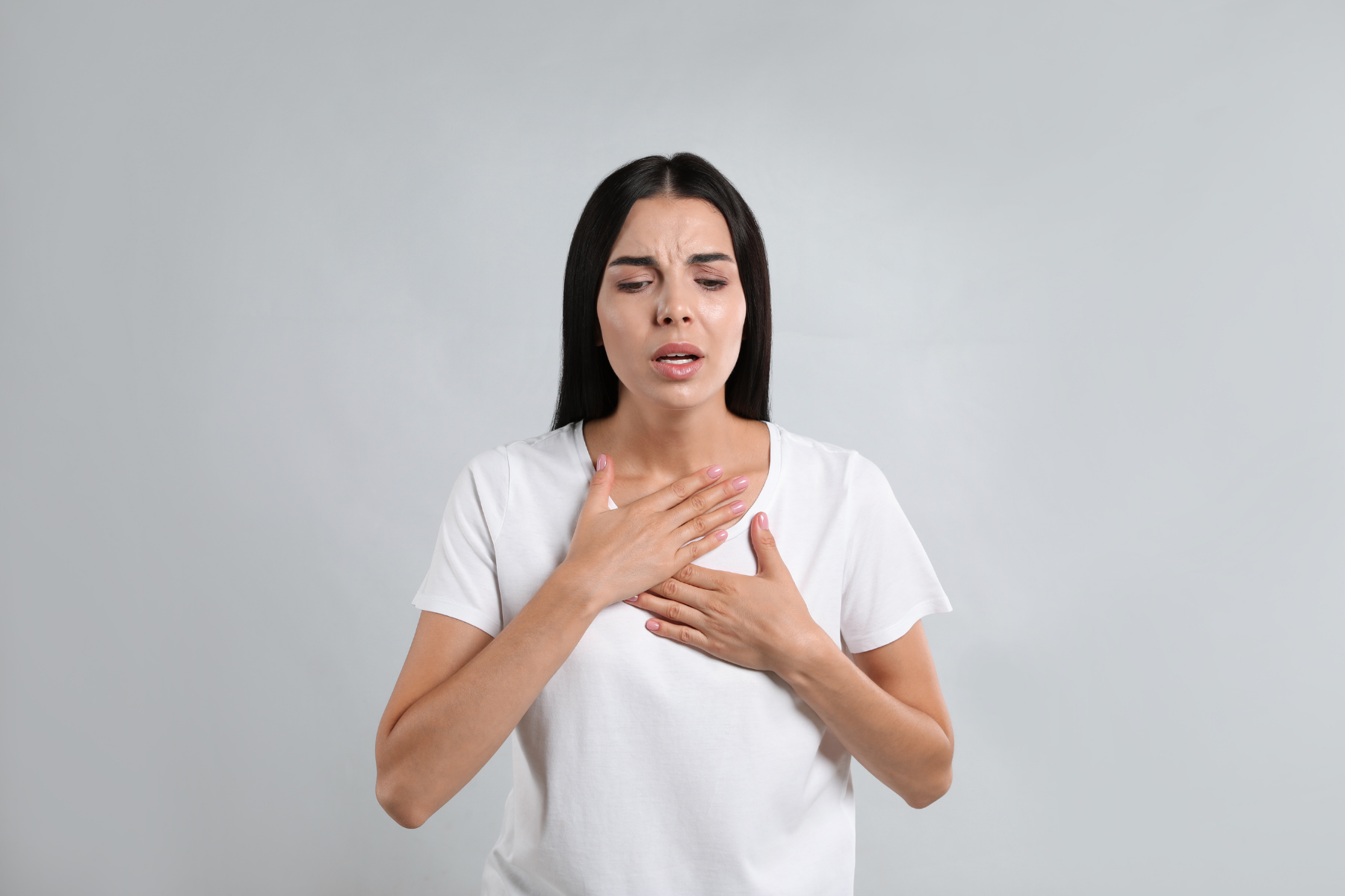 Woman experiencing chest discomfort and trouble breathing