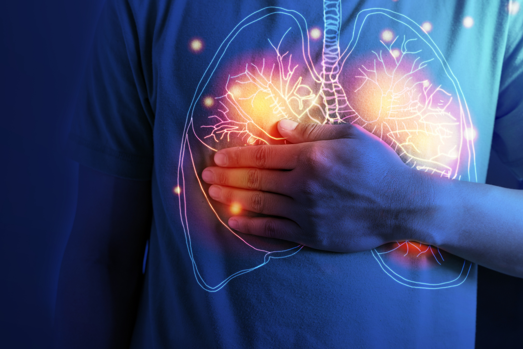 Illustration showing inflamed lungs with person clutching chest, representing breathing problems often seen in Antisynthetase Syndrome