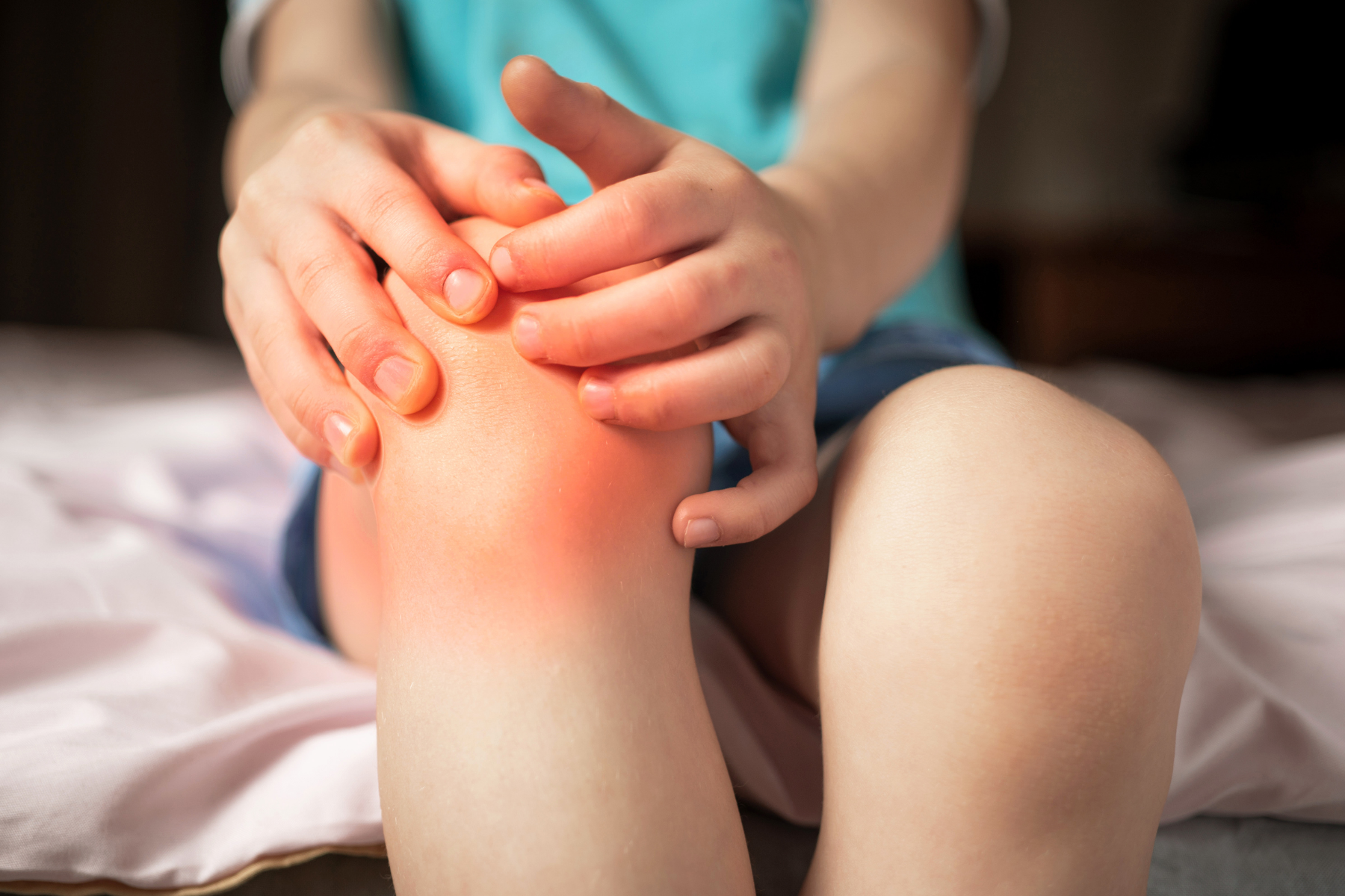 Close-up of inflamed, painful knee joint - a typical symptom children experience with Juvenile Idiopathic Arthritis