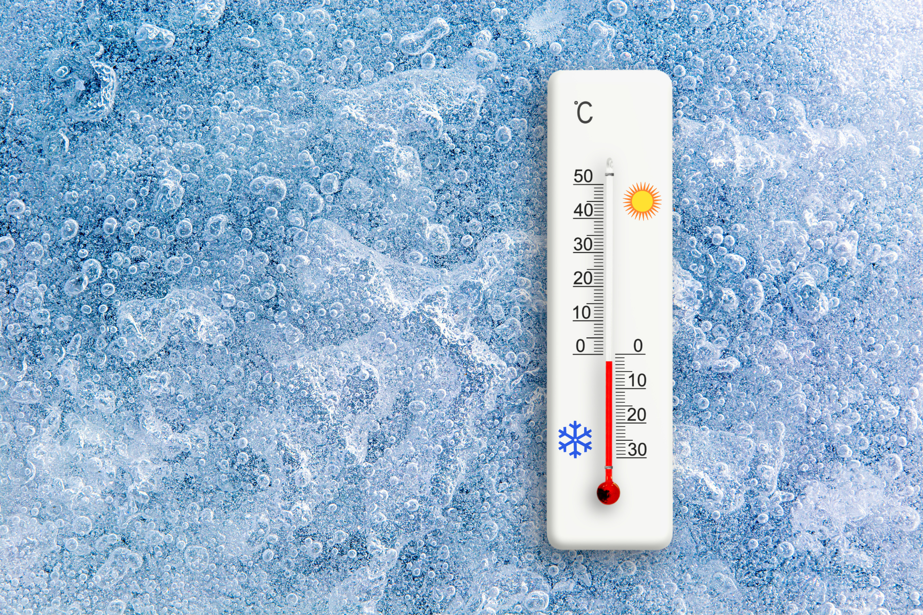 Thermometer showing cold temperature on icy background, illustrating how cold exposure can trigger CAPS symptoms