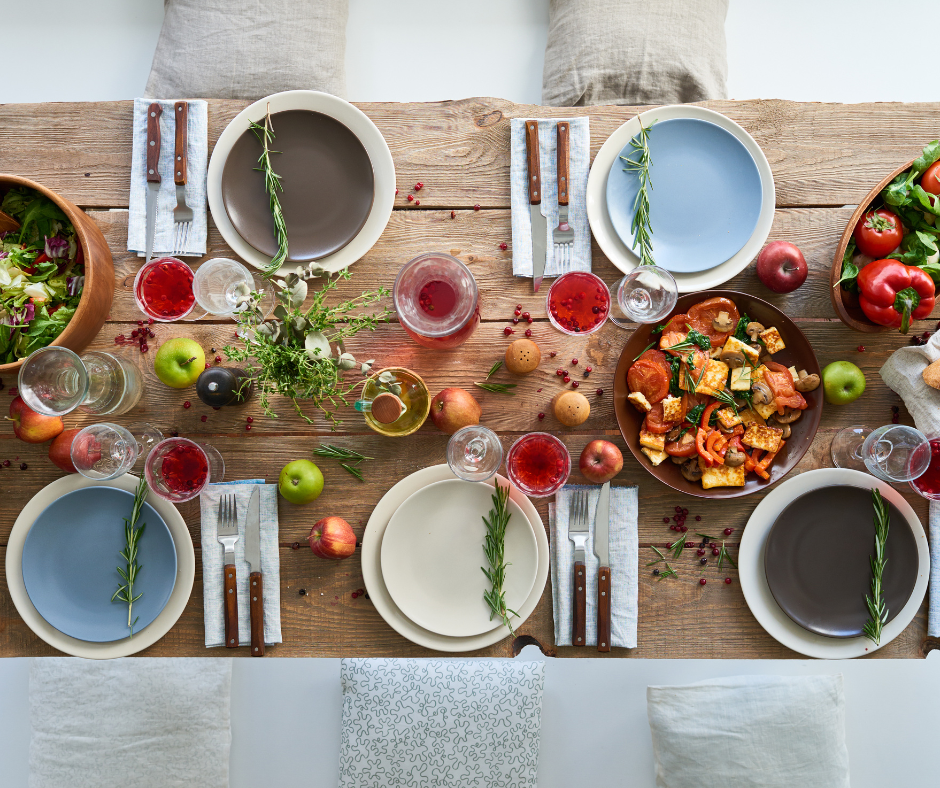 Dinner table with a display of plates and healthy dishes for dinner