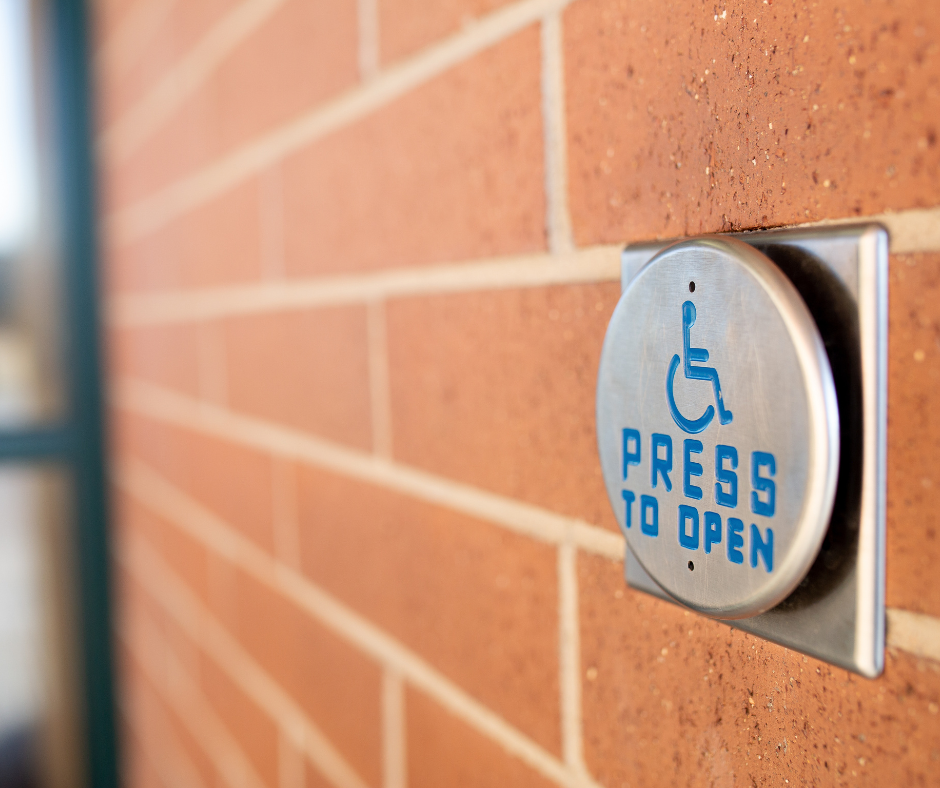 Brick wall with a disability door open push button