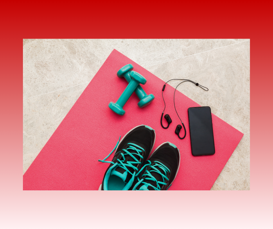 Exercise equipment on pink yoga mat: turquoise dumbbells, black and turquoise sneakers, phone and ea