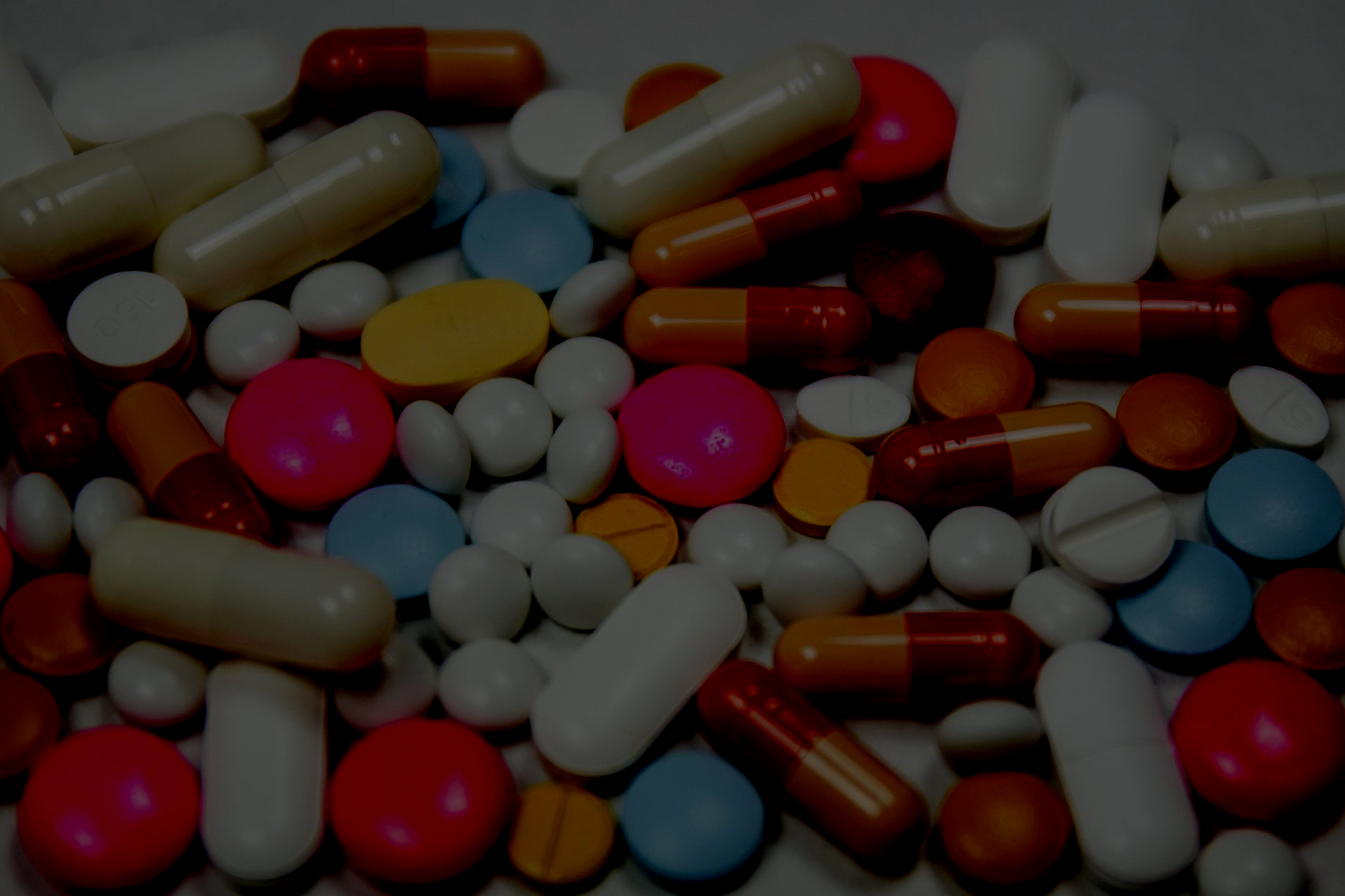 Close-up of various pills and capsules, representing medications.