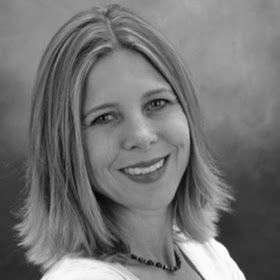 Florian Klett: Man with short dark hair wearing a collared shirt and dark vest, with a wide friendly smile