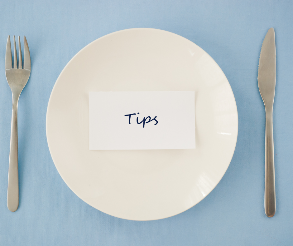 Empty plate with fork and knife and a piece of paper that says 