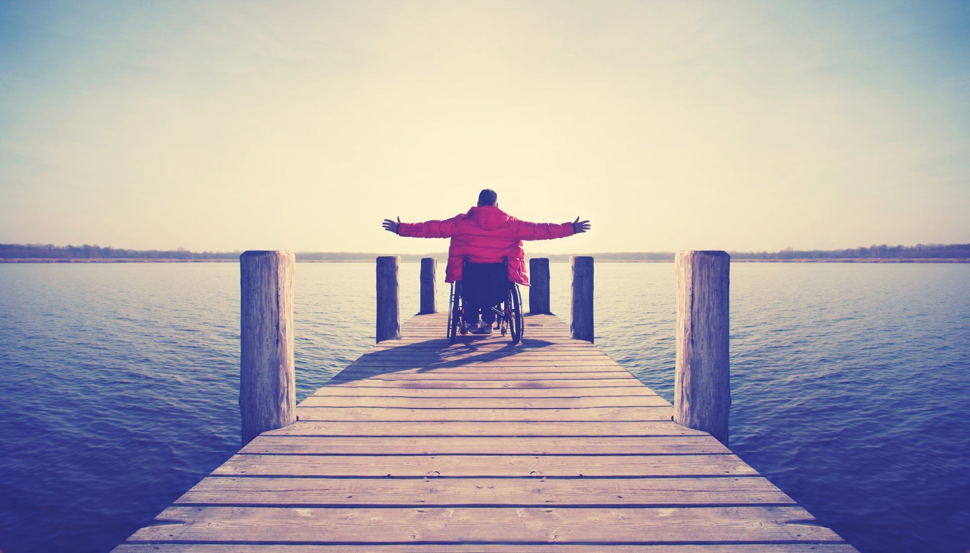 Person pointing at a brain scan; held up against a white wall.
