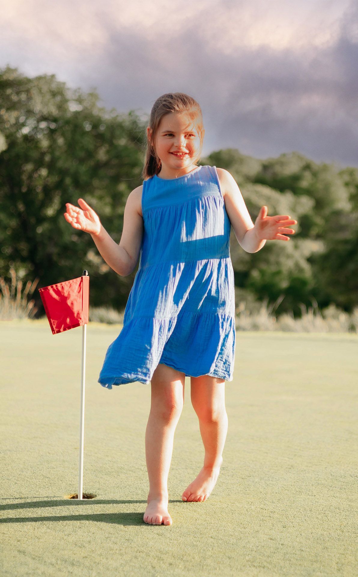 Remi standing next to a flag on a golf course