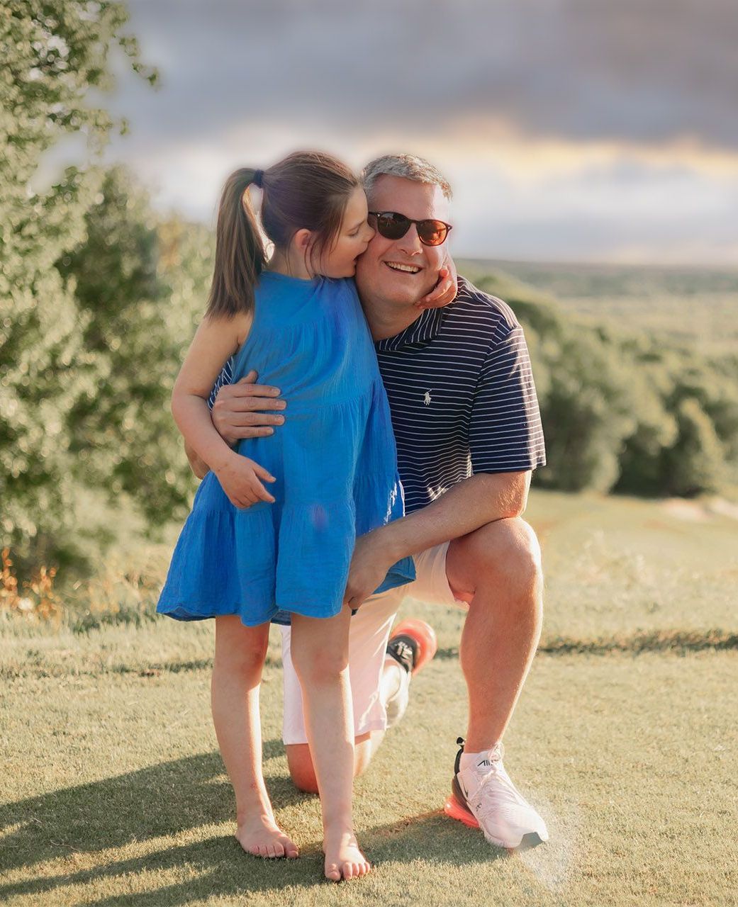 Remi and her dad, Dr. Matheson hugging on a golf course
