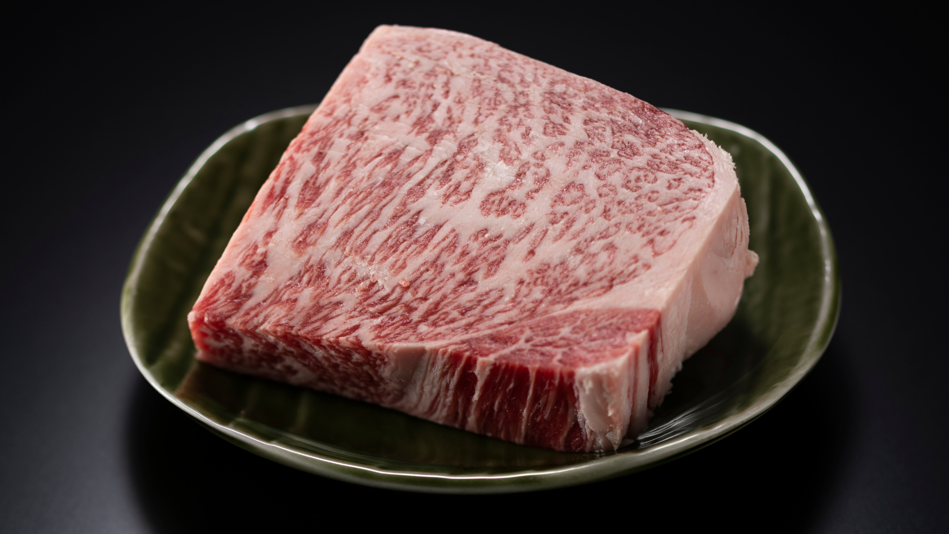 A bunch of meat in plastic bags on a wooden table.
