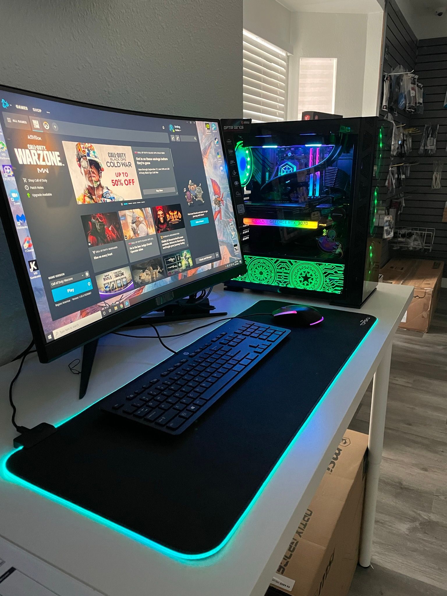 A computer is sitting on a desk next to a monitor and keyboard.