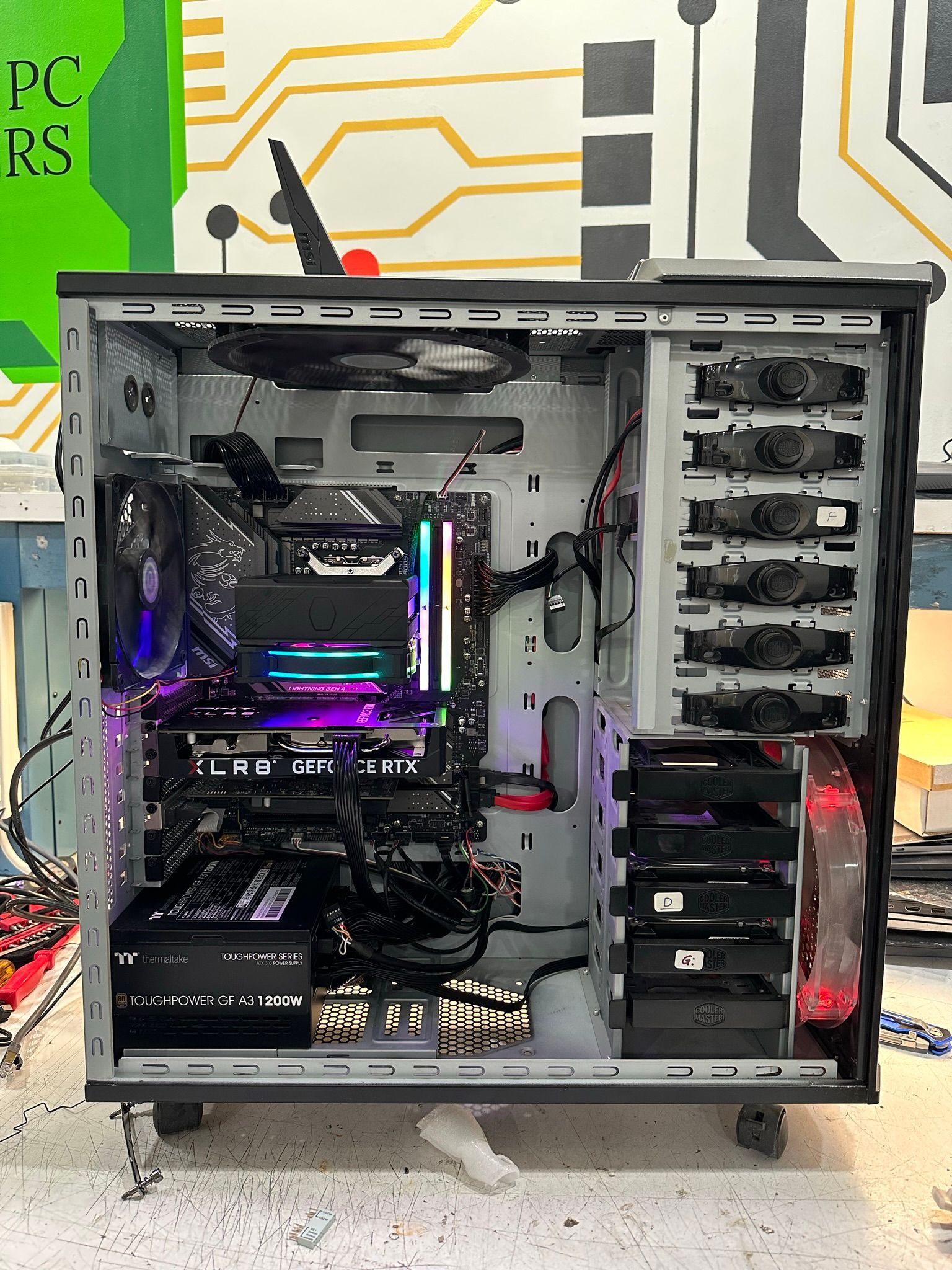 The inside of a computer case with a lot of electronics inside of it.