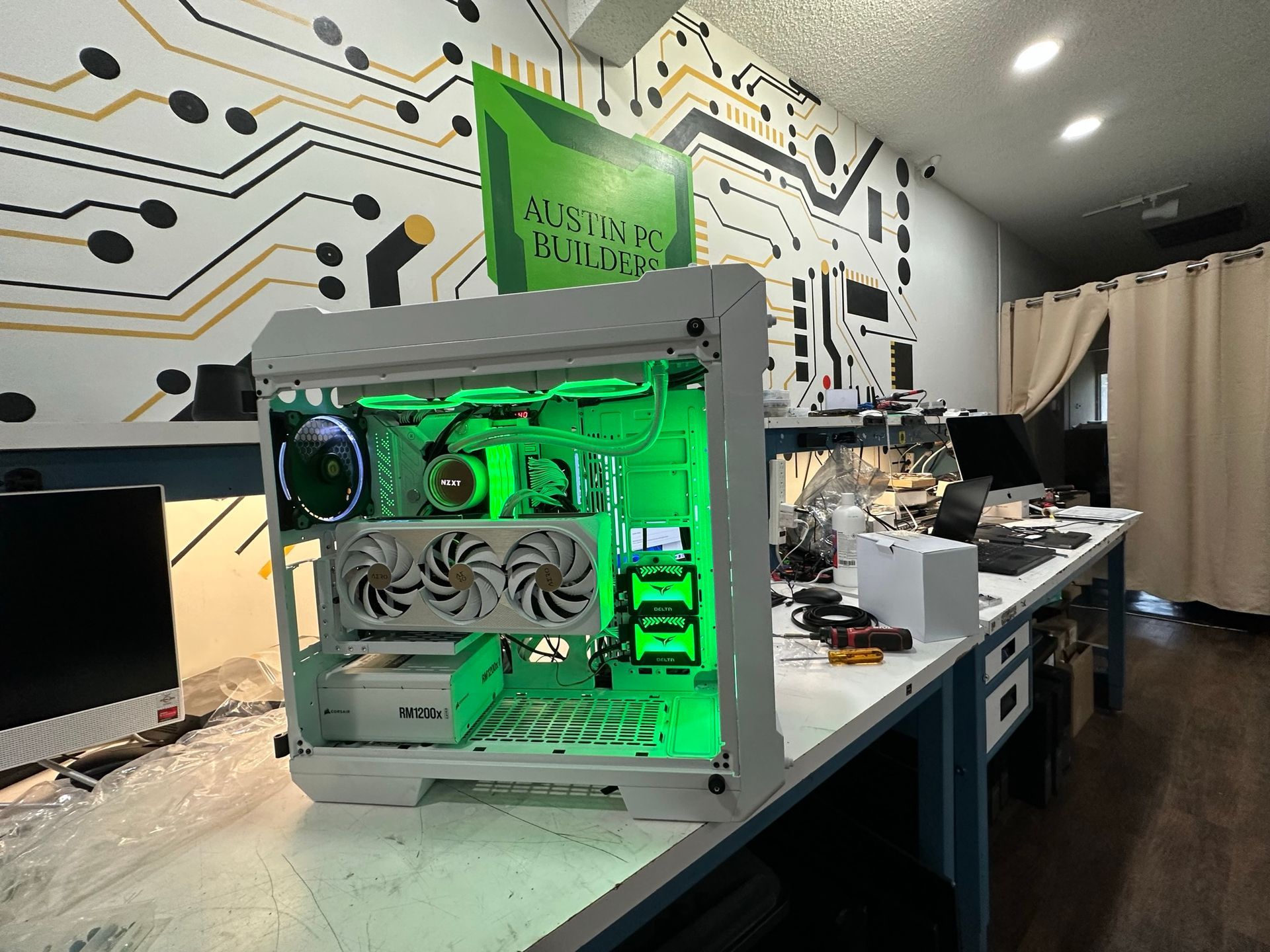 A computer case with green lights on it is sitting on a table.