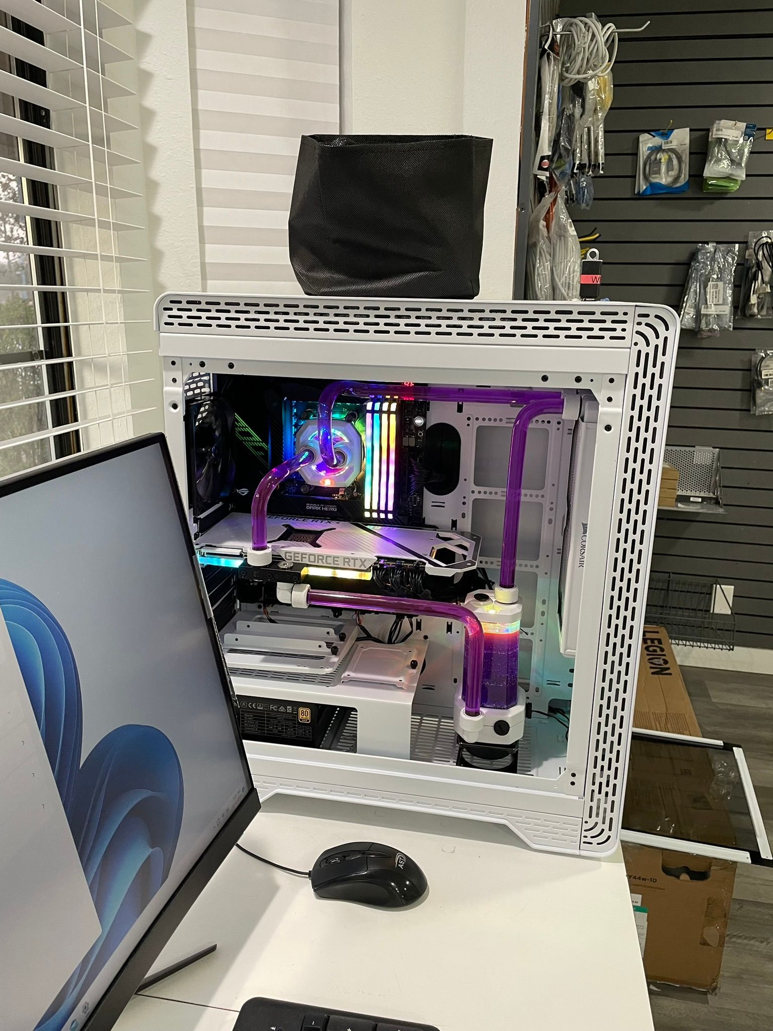 A computer case is sitting on top of a desk next to a computer monitor.