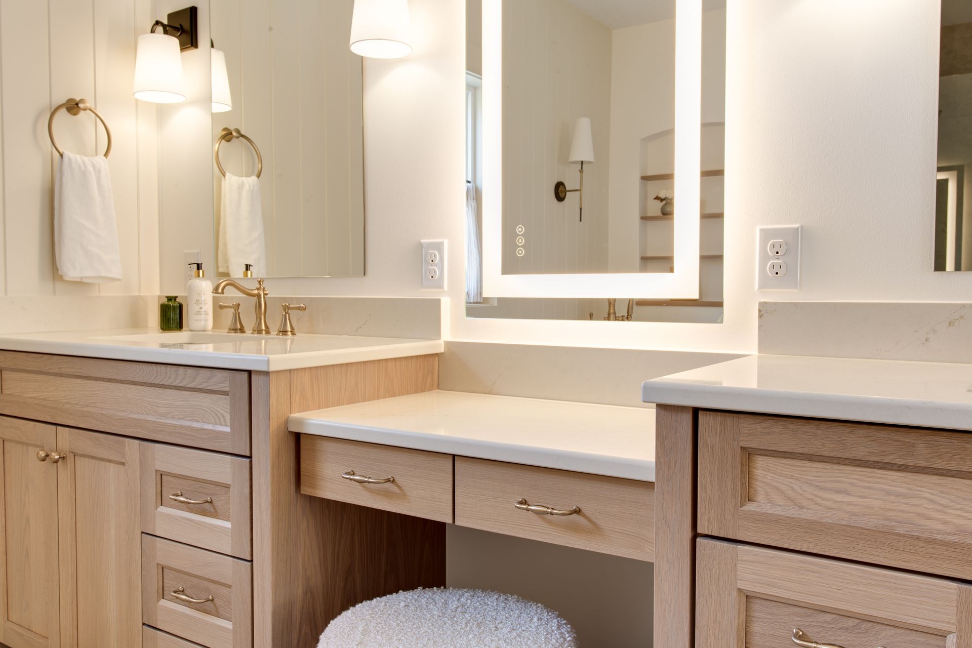 A bathroom with two sinks and two mirrors.