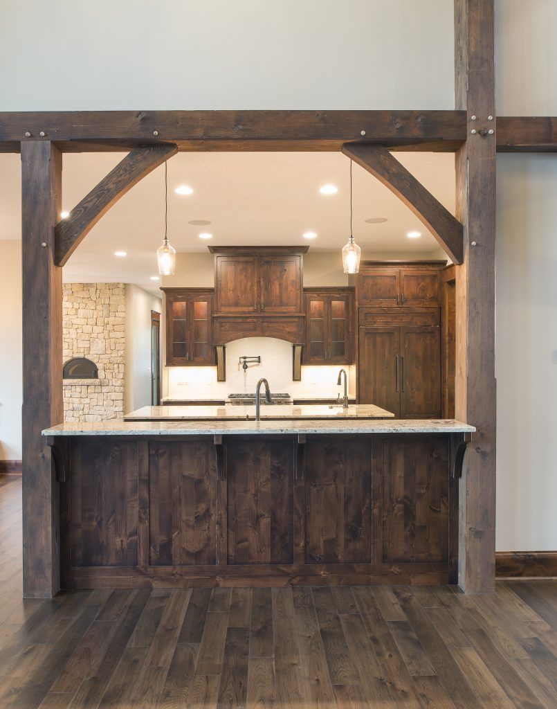 A kitchen with wooden cabinets and a large island.