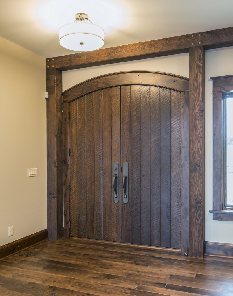 A room with a wooden door and a window.