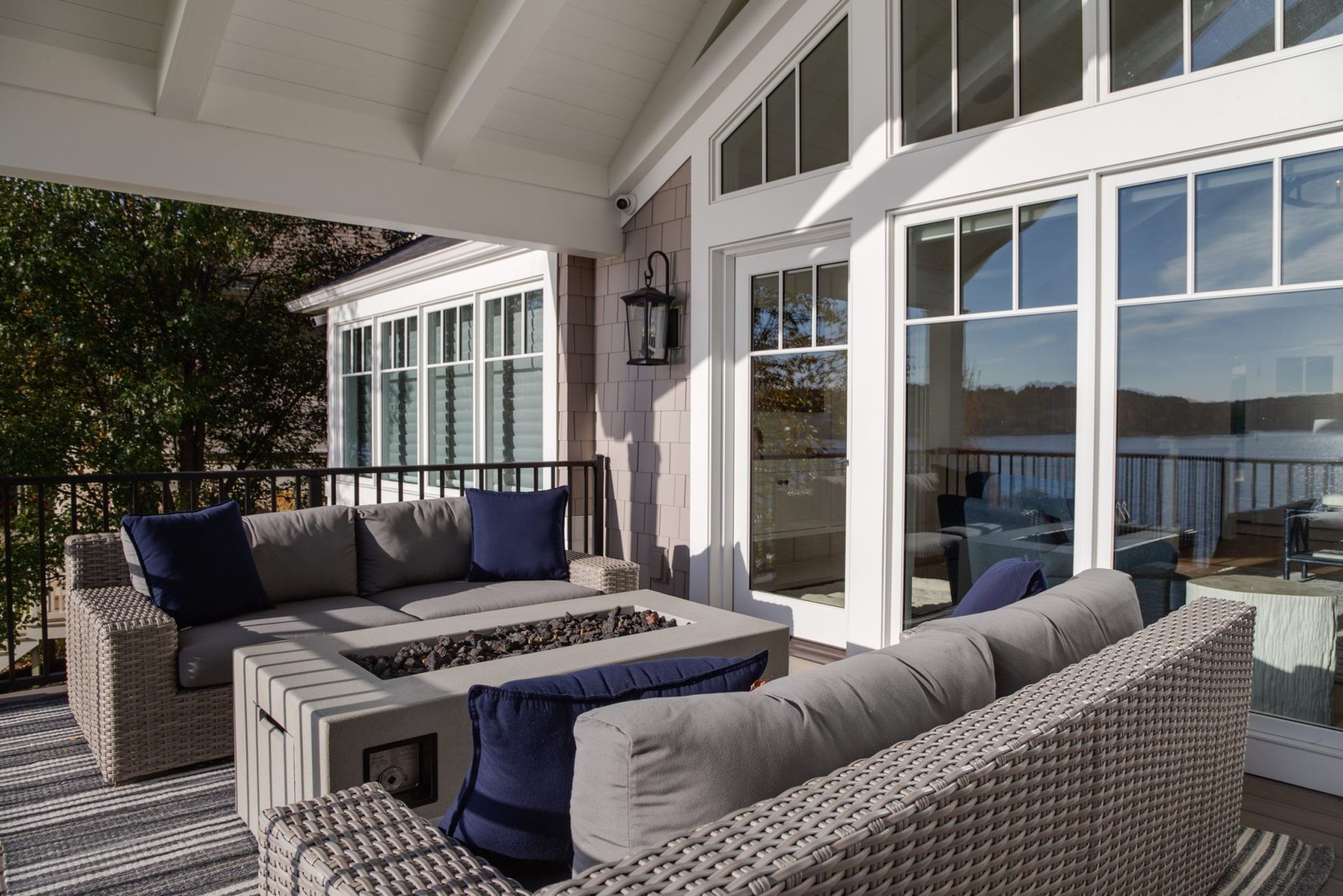 A patio with wicker furniture and a fire pit.