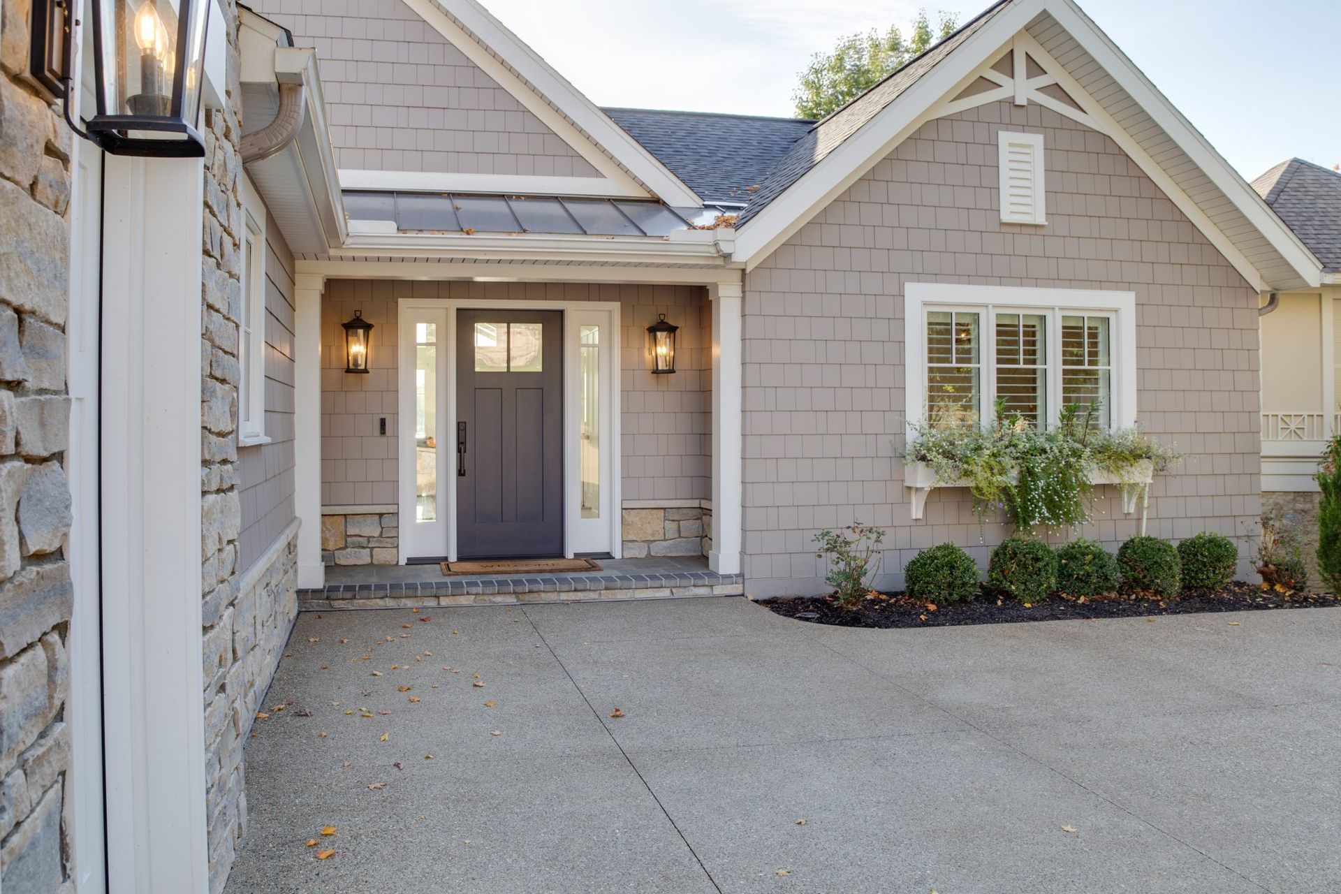 The front of a house with a driveway leading to it.