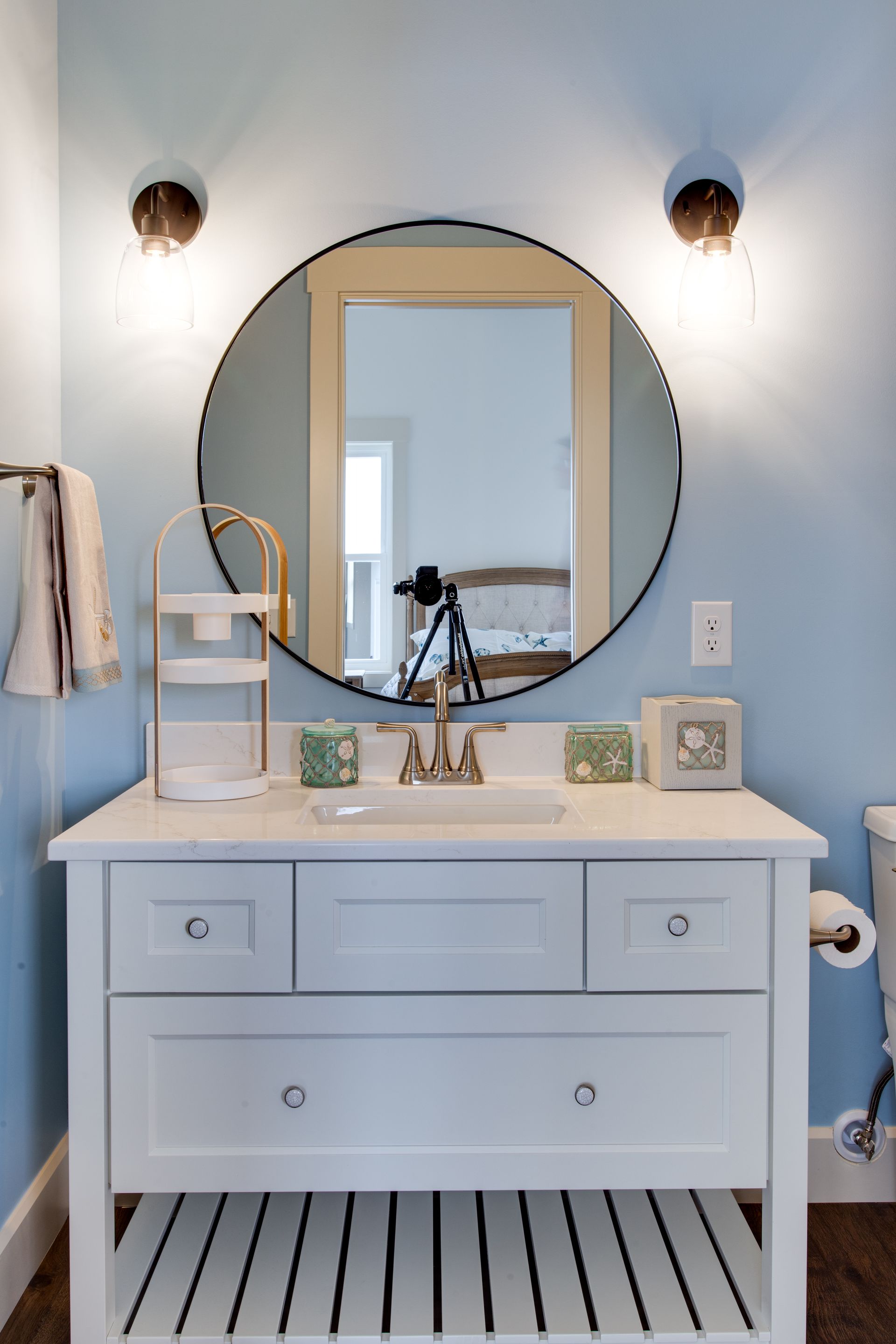 A bathroom with a sink, mirror and toilet.