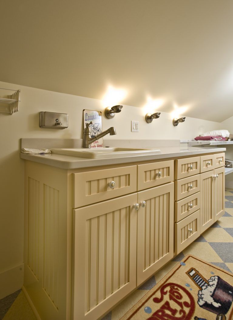 A kitchen with a coca cola rug on the floor.