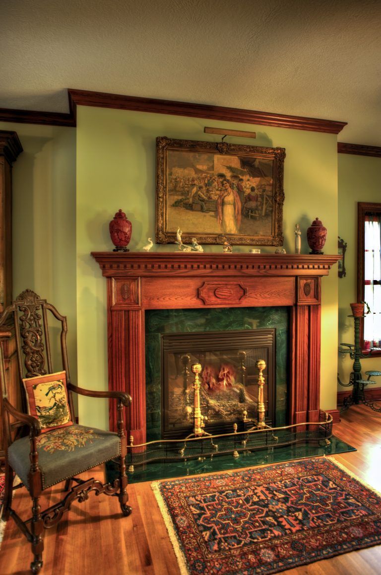 A living room with a fireplace and a chair.