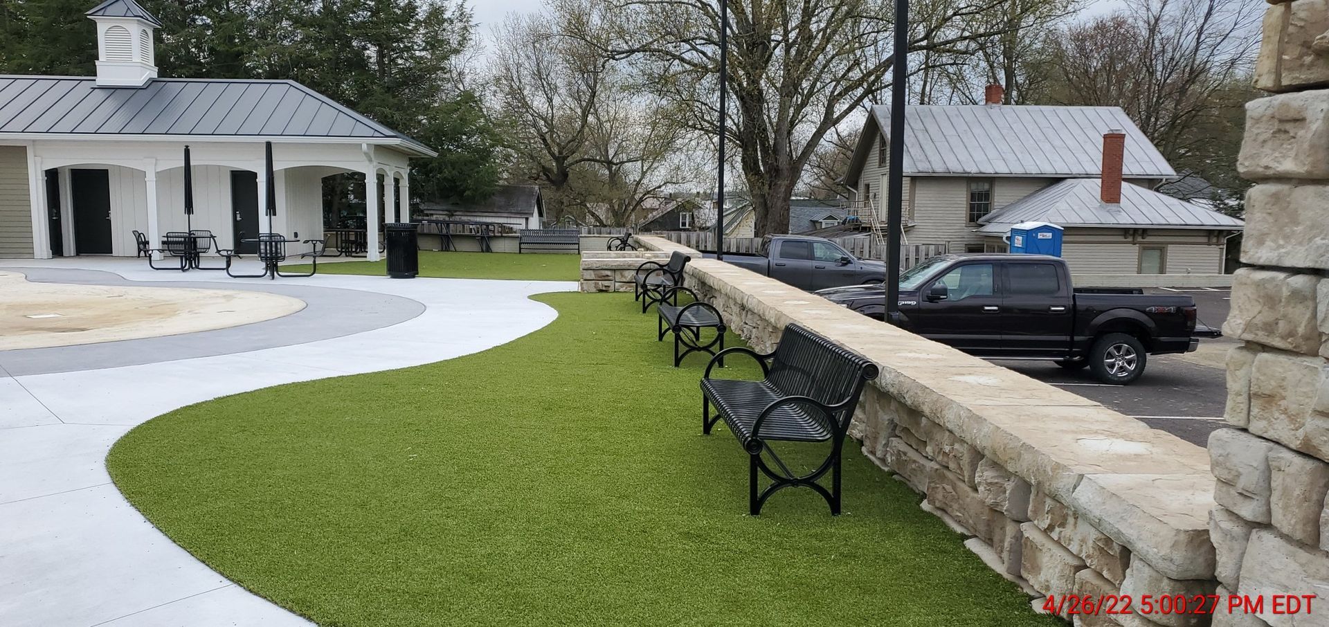 A black truck is parked in front of a building