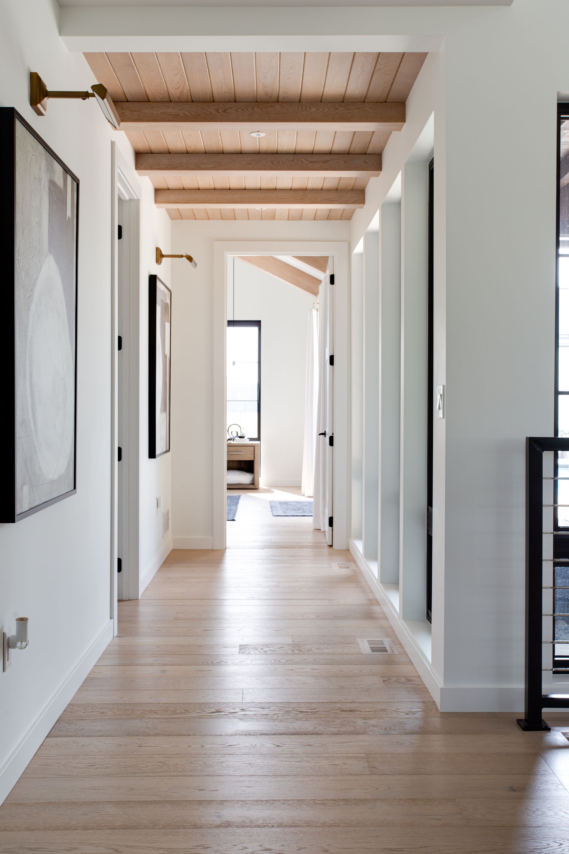 A long hallway with wooden floors and a wooden ceiling.