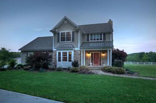 A large house with a large lawn in front of it.