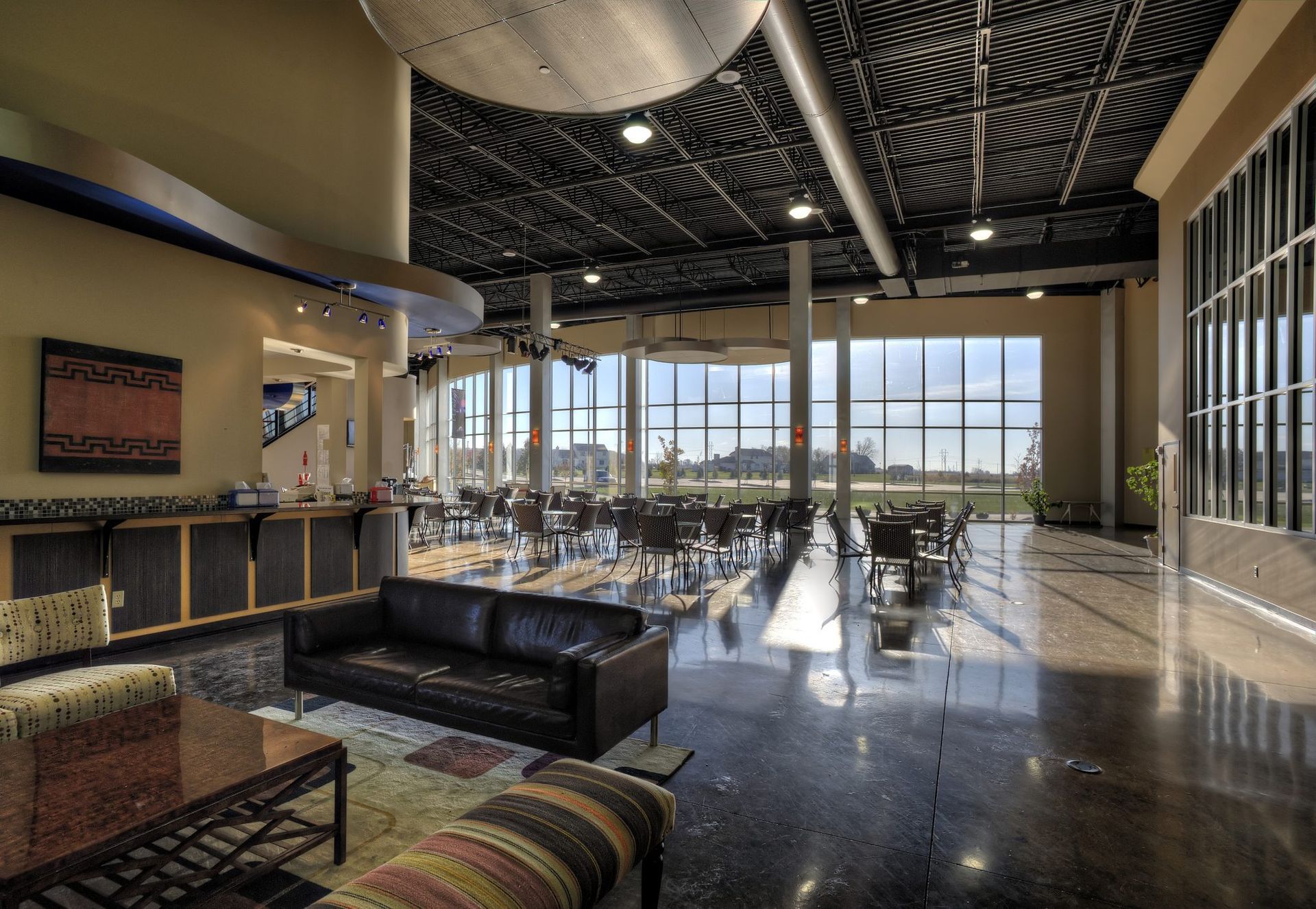 A large room with a couch and chairs in it.