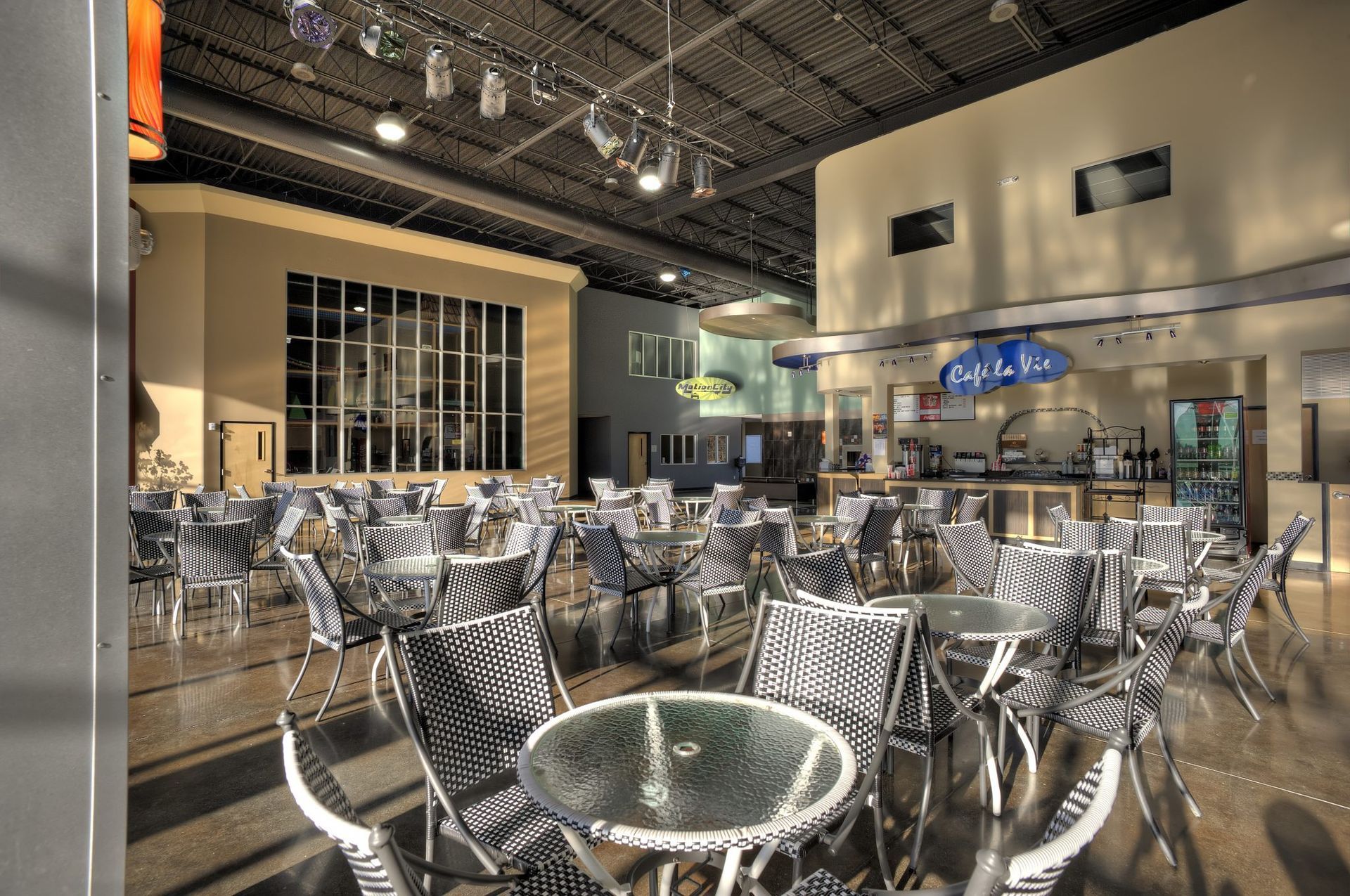An artist 's impression of a restaurant with tables and chairs.