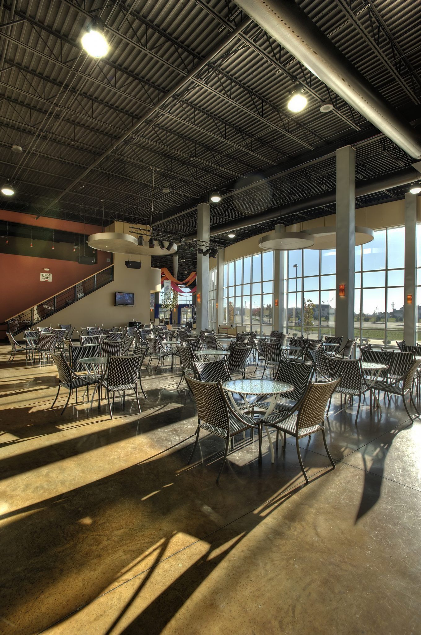 A large room with lots of tables and chairs.