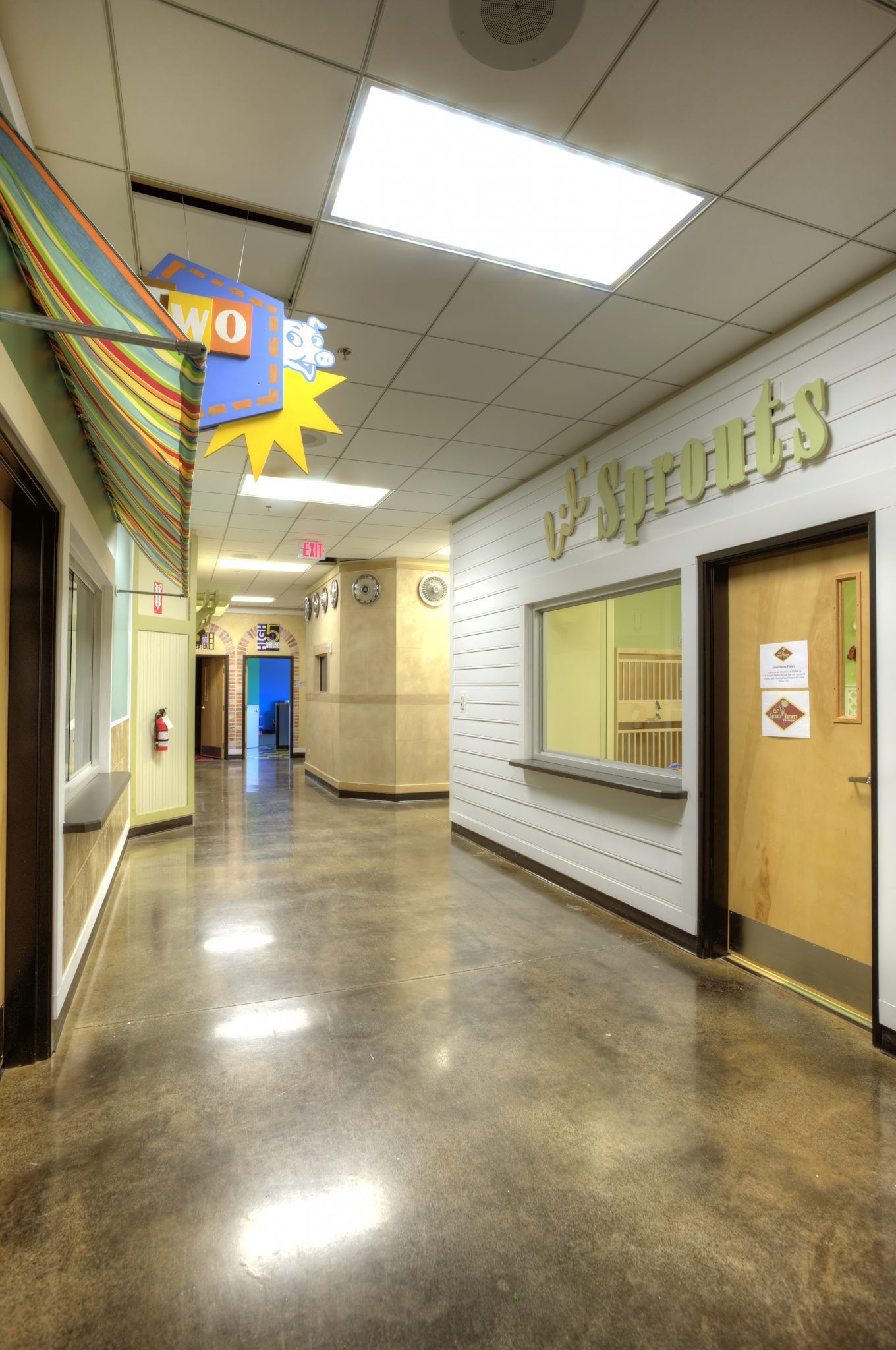A long hallway with a sign on the wall that says miracles.
