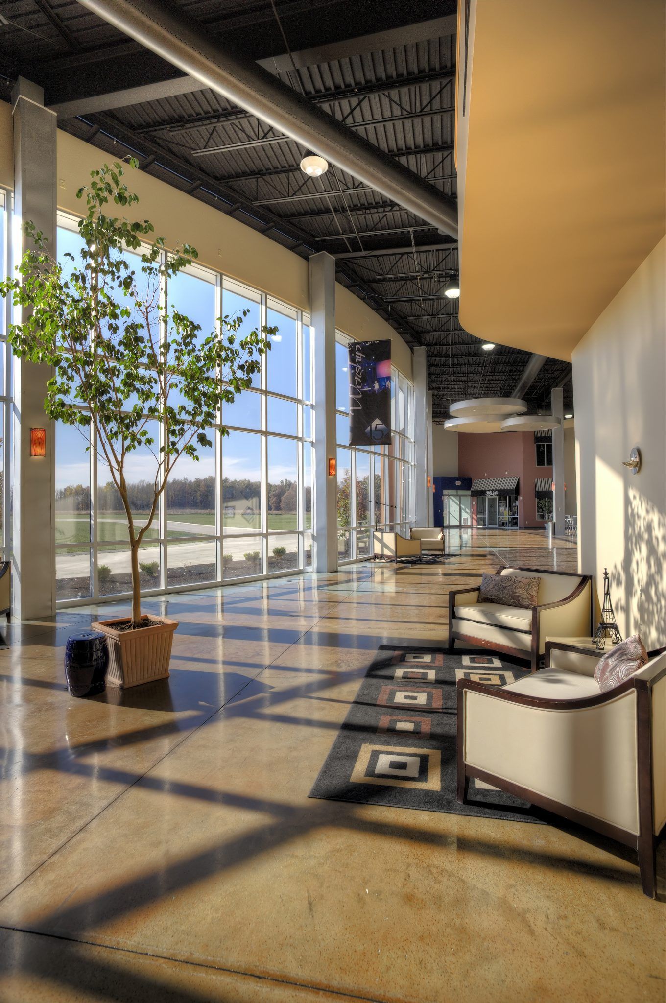 A large room with a lot of windows and chairs