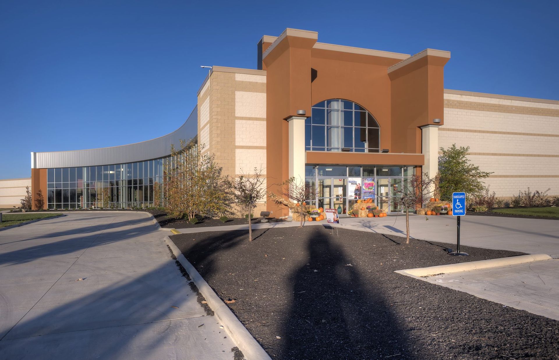 A large building with a handicapped parking sign in front of it