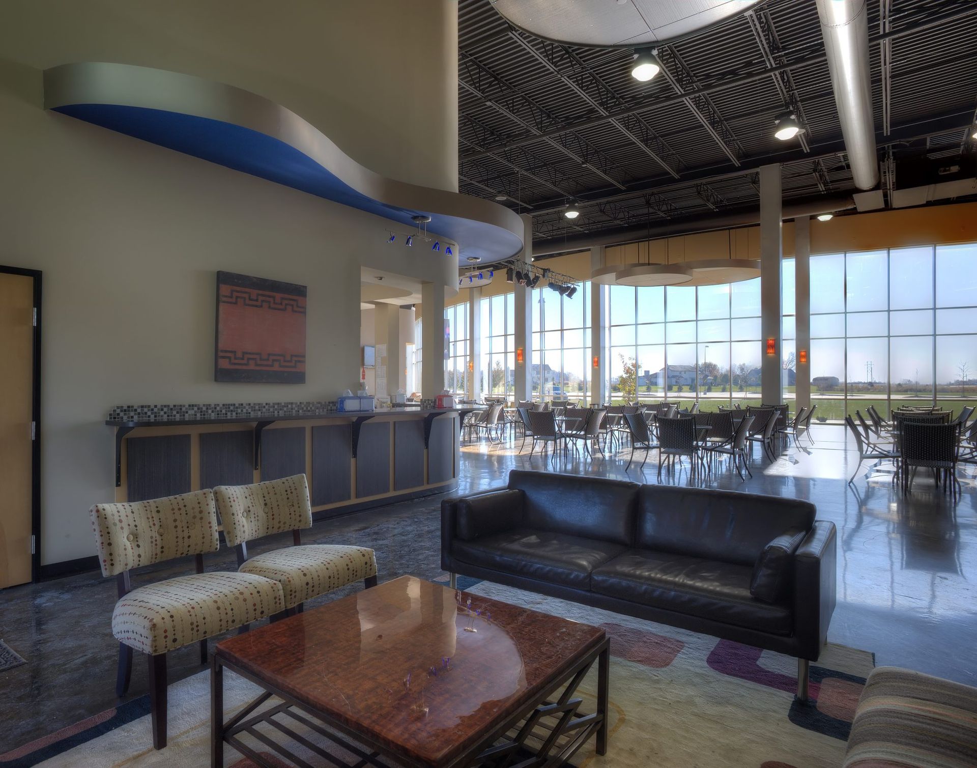 A living room with a couch a table and chairs.