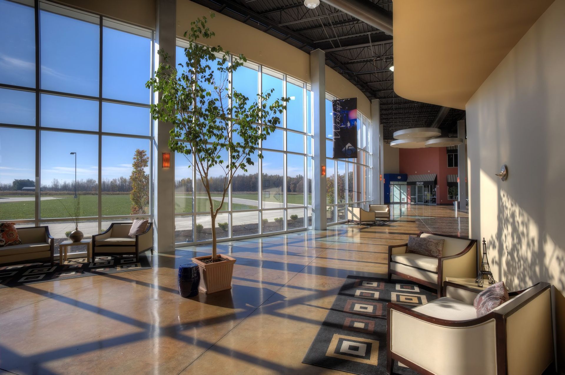 A large room with a lot of windows and furniture.