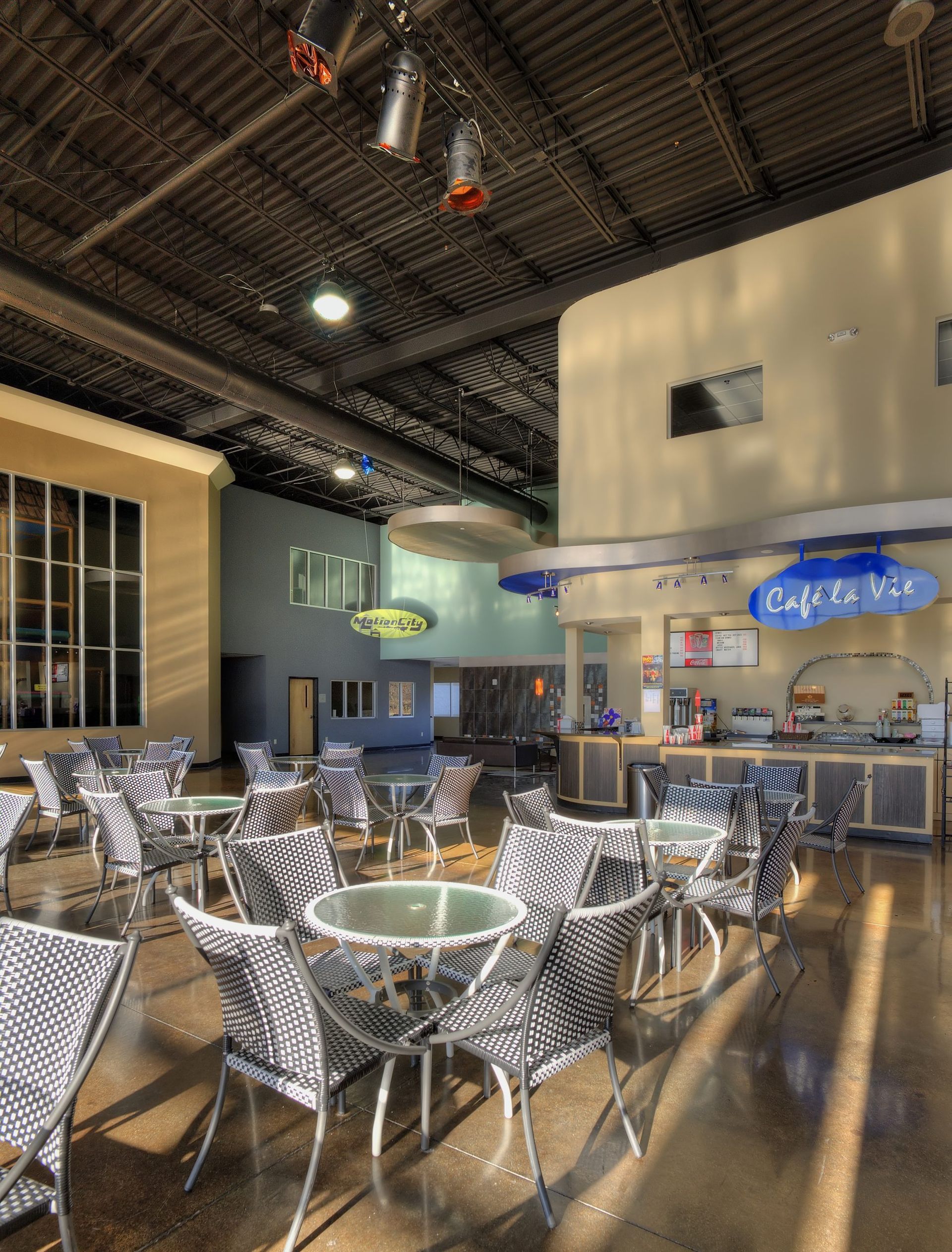 A restaurant with tables and chairs and a sign.