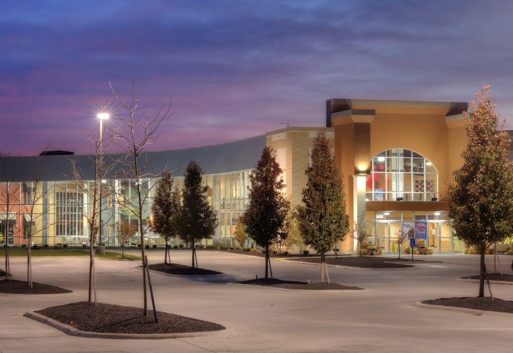 New Life Church building with a lot of windows and trees in front of it.