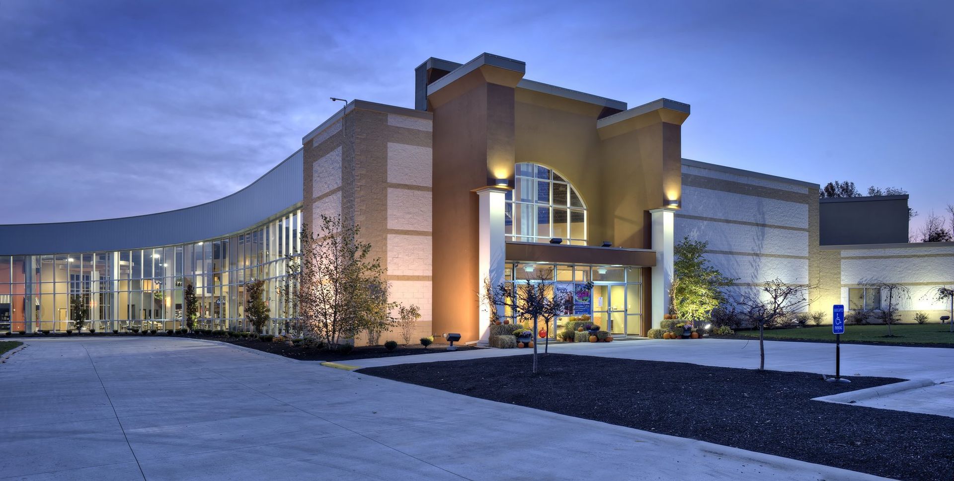 A large building with a lot of windows is lit up at night.
