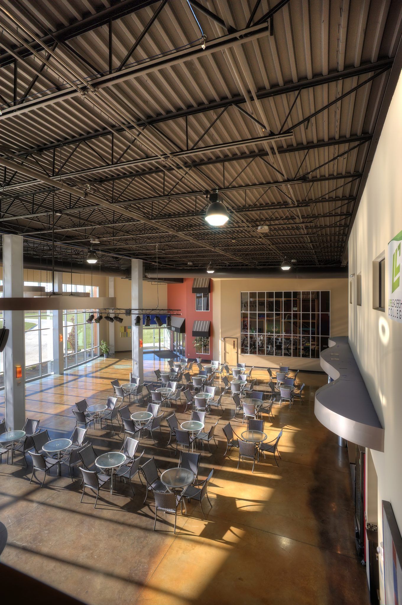 A large room with tables and chairs in it.