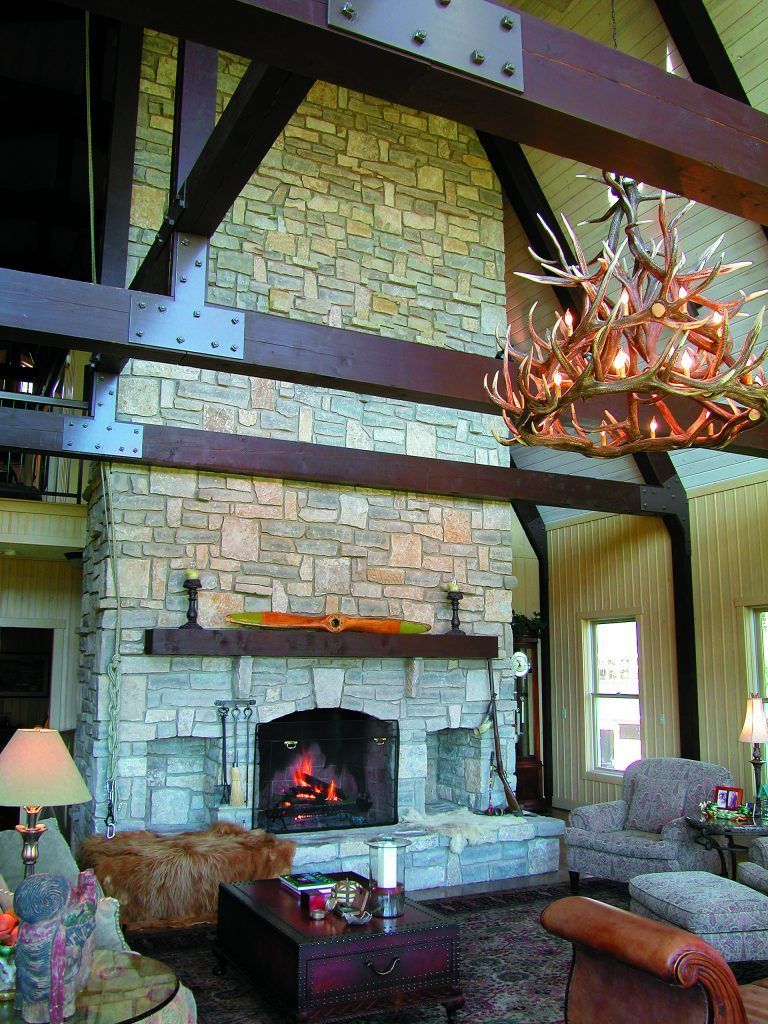 A living room with a fireplace and a chandelier.
